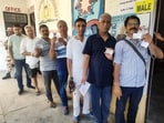 Kashmiri Pandits show their id cards as they wait in a queue to cast their vote for the Lok Sabha elections, in Anantnag on Saturday. Kashmiri Pandits show their id cards as they wait in a queue to cast their vote for the Lok Sabha elections, in Anantnag on Saturday.