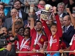 Manchester United's Alejandro Garnacho raises the trophy after his team won the English FA Cup final between Manchester City and Manchester United