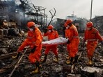 National Disaster Response Force (NDRF) officials carry a dead body on a stretcher at the site of a blast at a chemical factory in Dombivli, on the outskirts of Mumbai, India