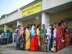 Voters queue up to cast their ballots at a polling station during the sixth phase of voting (AFP)
