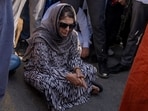 Jammu and Kashmir Peoples Democratic Party(PDP) president Mehbooba Mufti blocks a road with her supporters as she protests against the alleged detention of her party workers ahead of the sixth round of polling in India's national election in Bijehara, south of Srinagar, on Saturday.