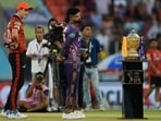Sunrisers Hyderabad's captain Pat Cummins, left, and Kolkata Knight Riders' captain Shreyas Iyer look at the winners trophy. Sunrisers Hyderabad's captain Pat Cummins, left, and Kolkata Knight Riders' captain Shreyas Iyer look at the winners trophy.