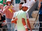 Serbia's Novak Djokovic hugs Spain's Rafael Nadal during a practice session.
