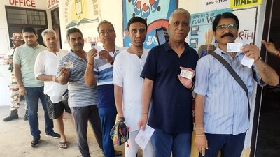 Kashmiri Pandits show their id cards as they wait in a queue to cast their vote for the Lok Sabha elections, in Anantnag on Saturday. (ANI)