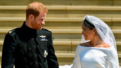 Prince Harry and Meghan Markle walk down the steps after their wedding. (AP)