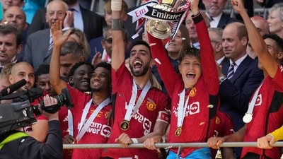 Manchester United's Alejandro Garnacho raises the trophy after his team won the English FA Cup final between Manchester City and Manchester United (AP) Manchester United's Alejandro Garnacho raises the trophy after his team won the English FA Cup final between Manchester City and Manchester United (AP)