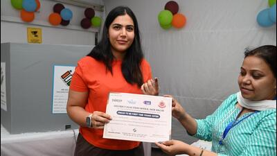 First-time voter Sanjana receives a certificate upon casting her vote at Nirman Bhawan in New Delhi on Saturday. (Arvind Yadav/HT Photo) First-time voter Sanjana receives a certificate upon casting her vote at Nirman Bhawan in New Delhi on Saturday. (Arvind Yadav/HT Photo)