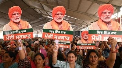 Supporters hold cut-outs of Prime Minister Narendra Modi during an election campaign rally in Gurdaspur. (AFP)