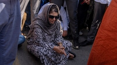 Jammu and Kashmir Peoples Democratic Party(PDP) president Mehbooba Mufti blocks a road with her supporters as she protests against the alleged detention of her party workers ahead of the sixth round of polling in India's national election in Bijehara, south of Srinagar, on Saturday. (AP)