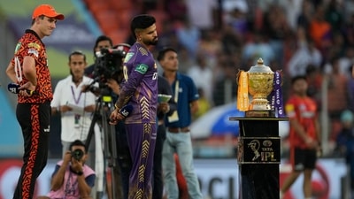 Sunrisers Hyderabad's captain Pat Cummins, left, and Kolkata Knight Riders' captain Shreyas Iyer look at the winners trophy. (AP)