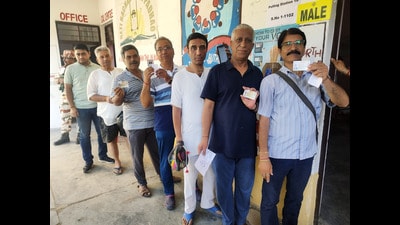 Kashmiri Pandits show their id cards as they wait in a queue to cast their vote for the Lok Sabha elections, in Anantnag on Saturday. (ANI) Kashmiri Pandits show their id cards as they wait in a queue to cast their vote for the Lok Sabha elections, in Anantnag on Saturday. (ANI)