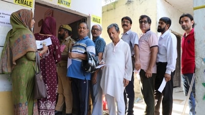 Kashmiri migrants wait in queues to cast their votes at a polling booth during the sixth phase of Lok Sabha elections, in Jammu. (PTI)