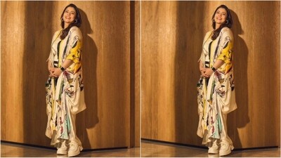 Her outfit consists of a white satin top embellished with crystals. She paired it with a silk skirt with a trendy black and white striped pattern. For added drama, she wore a drawstring cape adorned with trendy graphics, giving her look a truly chic vibe. (Instagram/@kajol)