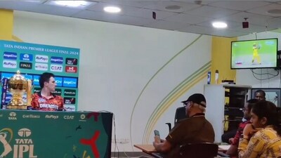 Pat Cummins watches MS Dhoni's shot on TV (X) Pat Cummins watches MS Dhoni's shot on TV (X)