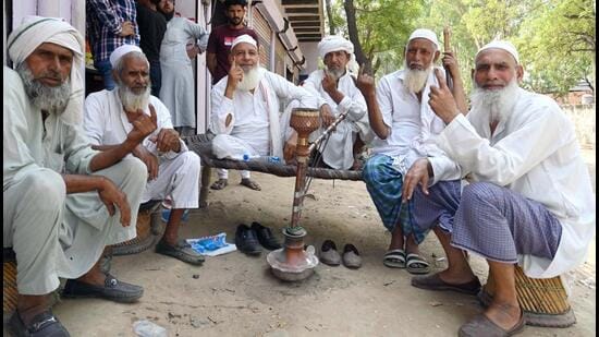 A group of elderly people showing their inked finger after casting their vote in the sixth phase of the Lok Sabha election at a polling station in Ferozepur Namak at Mewat, Nuh on Saturday. (Parveen Kumar/HT PHOTO)