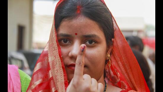 A woman shows her finger marked with indelible ink after casting vote at a polling station during the sixth phase of Lok Sabha elections in Gurugram on Saturday. (PTI)