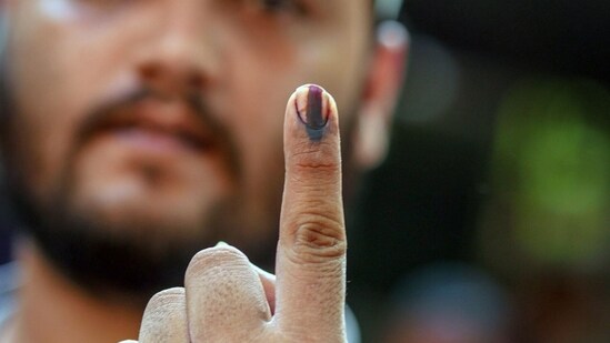 A voter's finger is marked with indelible ink after casting a ballot at a polling station during Lok Sabha election 2024. (Dhiraj Singh/Bloomberg)