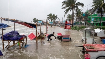 A man salvages a cart and other material as water flows on to the Kuakata beach on the coast of Bay of Bengal caused by the advancing Cyclone Remal in Barisal, Bangladesh, (AP) A man salvages a cart and other material as water flows on to the Kuakata beach on the coast of Bay of Bengal caused by the advancing Cyclone Remal in Barisal, Bangladesh, (AP)