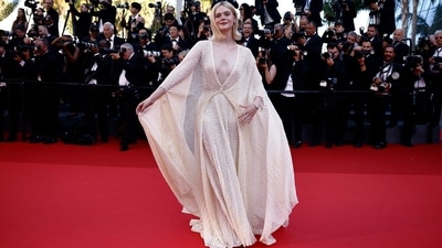 Cannes Film Festival 2024: Elle Fanning poses on the red carpet during the closing ceremony. For her red carpet look, she embraced spring and summer aesthetics, choosing a white sheer gown adorned with daisy patterns all over. She wore the plunging-neck ensemble with minimal jewels and a soft glam look.&nbsp; (REUTERS)