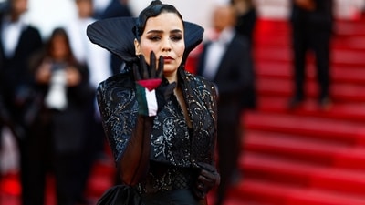 Cannes Film Festival 2024: Moroccan director, screenwriter and member of the Un Certain Regard jury, Asmae El Moudir, holds a Palestinian flag on her glove as she arrives for the Closing Ceremony. (AFP) Cannes Film Festival 2024: Moroccan director, screenwriter and member of the Un Certain Regard jury, Asmae El Moudir, holds a Palestinian flag on her glove as she arrives for the Closing Ceremony. (AFP)