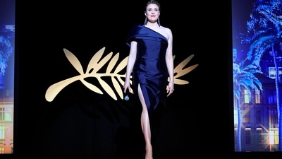 Cannes Film Festival 2024: President of the Jury of the 77th Cannes Film Festival, Greta Gerwig, opted for a one-shoulder black satin gown for the closing ceremony. The ensemble comes with a thigh-high slit ad a figure-hugging silhouette. She styled the look with diamond jewels, a backswept hairdo, bold red lips, and striking glam. (AFP) Cannes Film Festival 2024: President of the Jury of the 77th Cannes Film Festival, Greta Gerwig, opted for a one-shoulder black satin gown for the closing ceremony. The ensemble comes with a thigh-high slit ad a figure-hugging silhouette. She styled the look with diamond jewels, a backswept hairdo, bold red lips, and striking glam. (AFP)