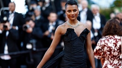 Cannes Film Festival 2024: Bridgerton actor Simone Ashley walked the red carpet for the Closing Ceremony at the 77th edition of the Cannes Film Festival. She chose a strapless black gown for the occasion, which she styled with jewels from Tiffany, a coiffed hairdo, black pumps, and striking glam. (AFP) Cannes Film Festival 2024: Bridgerton actor Simone Ashley walked the red carpet for the Closing Ceremony at the 77th edition of the Cannes Film Festival. She chose a strapless black gown for the occasion, which she styled with jewels from Tiffany, a coiffed hairdo, black pumps, and striking glam. (AFP)