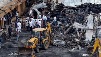 Officials inspect the site of a fire accident on the following day of the disaster, at an amusement park facility in Rajkot, in India's Gujarat state on May 26, 2024. Four young children were among 27 people killed when a fire in India ripped through a crowded amusement park, police said, as rescuers on May 26 scoured the site the morning after the blaze. (Photo by AFP) (AFP) Officials inspect the site of a fire accident on the following day of the disaster, at an amusement park facility in Rajkot, in India's Gujarat state on May 26, 2024. Four young children were among 27 people killed when a fire in India ripped through a crowded amusement park, police said, as rescuers on May 26 scoured the site the morning after the blaze. (Photo by AFP) (AFP)