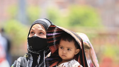 A woman covers her child in protection from the scorching sun on a hot summer day, in Jaipur. (PTI) A woman covers her child in protection from the scorching sun on a hot summer day, in Jaipur. (PTI)