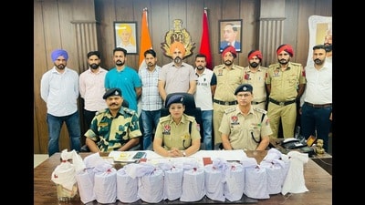 Police and BSF officials giving details about the seizure of drugs and the arrests in Fazilka on Sunday. (HT photo) Police and BSF officials giving details about the seizure of drugs and the arrests in Fazilka on Sunday. (HT photo)
