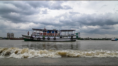 Police personnel make announcements ahead of Cyclone Remal’s landfall at the Hooghly river, in Kolkata, on Sunday. (PTI)