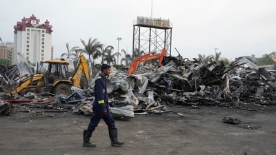 Firefighters stand next to burnt debris the day after a fire broke out in an amusement park in Rajkot, India, Sunday, May 26, 2024. (AP) Firefighters stand next to burnt debris the day after a fire broke out in an amusement park in Rajkot, India, Sunday, May 26, 2024. (AP)