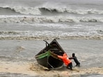 Cyclone Remal: Men push a fishing boat to a sea shore as a preventive measure during rainfall in Kuakata on May 26, 2024. Cyclone Remal: Men push a fishing boat to a sea shore as a preventive measure during rainfall in Kuakata on May 26, 2024.
