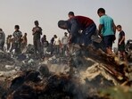 Palestinians gather at the site of an Israeli strike on a camp for internally displaced people in Rafah. (AFP)