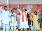 Union Home Minister Amit Shah greets people during a public meeting for the Lok Sabha polls, in Kushinagar on Monday. (ANI)