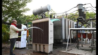 A worker sprays water on a monster cooler installed to keep the transformer cool at the GPRA power house in Jankipuram (Deepak Gupta/HT Photo) A worker sprays water on a monster cooler installed to keep the transformer cool at the GPRA power house in Jankipuram (Deepak Gupta/HT Photo)