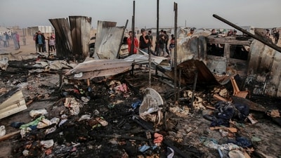 Palestinians look at the destruction after an Israeli strike where displaced people were staying in Rafah, Gaza Strip. (AP) Palestinians look at the destruction after an Israeli strike where displaced people were staying in Rafah, Gaza Strip. (AP)