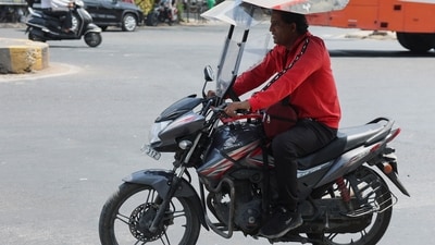 India heatwave: A man rides a motorcycle with a roof to protect himself from a heatwave on the street in Ahmedabad, India. (Reuters)