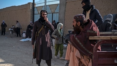 Taliban security personnel stand guard during the food distribution to Afghan people at Nawabad Kako Sahib area in Baraki Barak district. (AFP) Taliban security personnel stand guard during the food distribution to Afghan people at Nawabad Kako Sahib area in Baraki Barak district. (AFP)