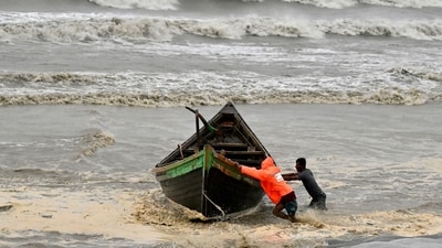 Cyclone Remal: Men push a fishing boat to a sea shore as a preventive measure during rainfall in Kuakata on May 26, 2024. (AFP) Cyclone Remal: Men push a fishing boat to a sea shore as a preventive measure during rainfall in Kuakata on May 26, 2024. (AFP)