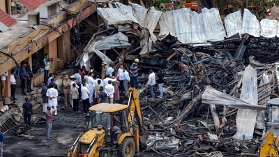 Officials inspect the site of a fire accident at a gaming zone in Rajkot on May 26, 2024. (AFP) Officials inspect the site of a fire accident at a gaming zone in Rajkot on May 26, 2024. (AFP)