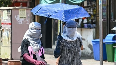 Women cover themselves with scarves and an umbrella to get shield from the sun during a hot summer day in New Delhi (AFP) Women cover themselves with scarves and an umbrella to get shield from the sun during a hot summer day in New Delhi (AFP)