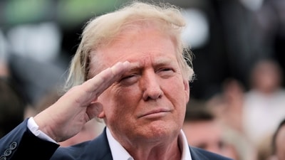 Former President Donald Trump salutes during opening ceremonies as he attends the NASCAR Coca-Cola 600 auto race, Sunday, May 26, 2024, in Concord, N.C. It is the first time that a president or former president has attended a race at Charlotte Motor Speedway. (AP Photo/Chris Seward) (AP)