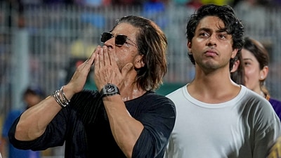 Chennai: Actor and Kolkata Knight Riders (KKR) co-owner Shah Rukh Khan greets the crowd as his son Aryan Khan looks on. (PTI) Chennai: Actor and Kolkata Knight Riders (KKR) co-owner Shah Rukh Khan greets the crowd as his son Aryan Khan looks on. (PTI)