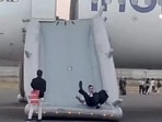 A pilot sliding down from the IndiGo flight. (PTI) A pilot sliding down from the IndiGo flight. (PTI)