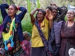 Villagers react as they search through a landslide in Yambali village, in the Highlands of Papua New Guinea, Monday, May 27, 2024. 