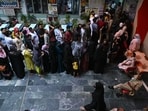 Voters queue up to cast their ballots at a polling station during the sixth phase of voting in India's general election in New Delhi on May 25, 2024. India is voting in seven phases over six weeks to ease the immense logistical burden of staging an election in the world's most populous country. (Photo by Arun SANKAR / AFP)
