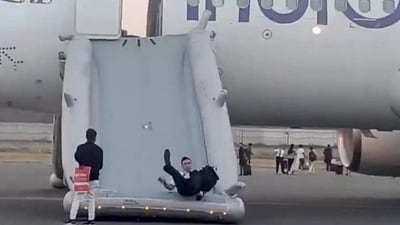 A pilot sliding down from the IndiGo flight. (PTI) A pilot sliding down from the IndiGo flight. (PTI)