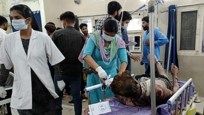 An injured worker being treated at a hospital after a fire broke out in Sonepat on Tuesday. (PTI)