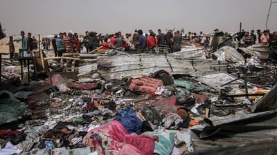 Palestinians inspect damage at the site of an Israeli strike on an area designated for displaced people in Rafah, southern Gaza Strip, on Monday, May 27, 2024. At least 40 Palestinians were killed in an Israeli airstrike at a camp for displaced people in the southern city of Rafah late Sunday, the Hamas-run ministry of health said.�Photographer: Ahmad Salem/Bloomberg (Bloomberg)