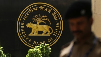 A police officer walks past the Reserve Bank of India (RBI) logo inside its headquarters in Mumbai, India. (Reuters)